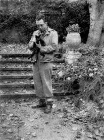 F821 Albert Camus avec son chat à Bougival, dans la propriété de Guy Shoeller, pendant la pièce de théâtre Caligula, novembre 1945.